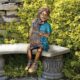 design-toscano-puppy-kisses-sitting-girl-cast-bronze-garden-statue-pn6570